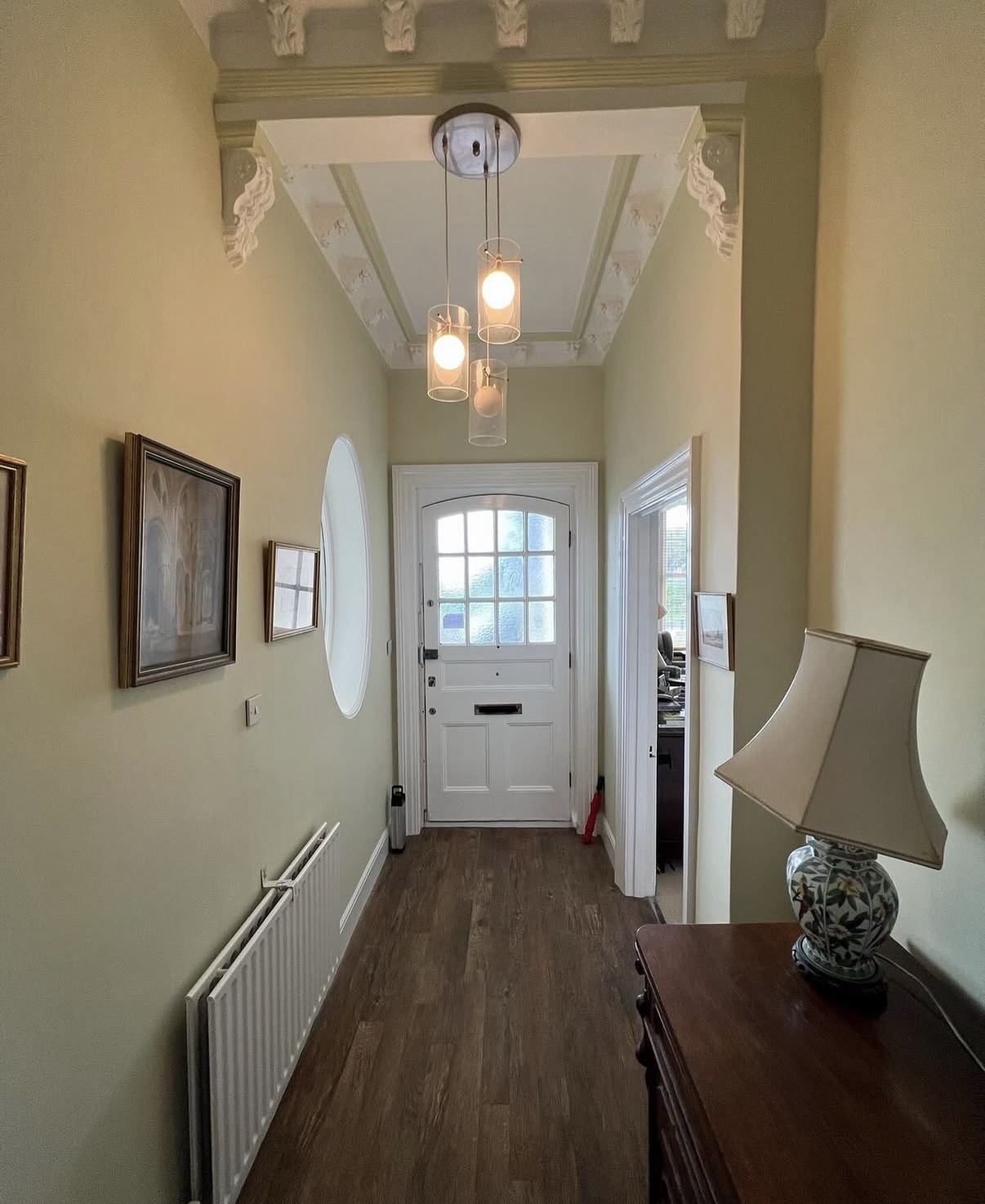 Period Victorian hallway painted sage green with ornate cornicing by Hamilton Decorating East Sussex